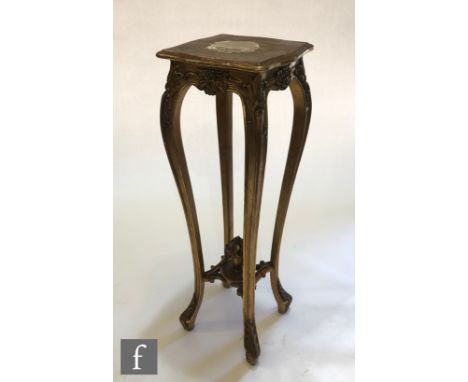 A late 19th to early 20th Century carved gilt jardiniere stand, the shaped top over slender legs united by an urn stretcher w