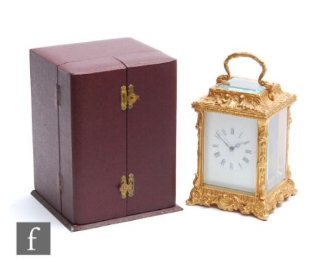 A 20th Century Fema brass carriage clock with Roman numerals to a white rectangular dial, to an ornate case decorated with ch