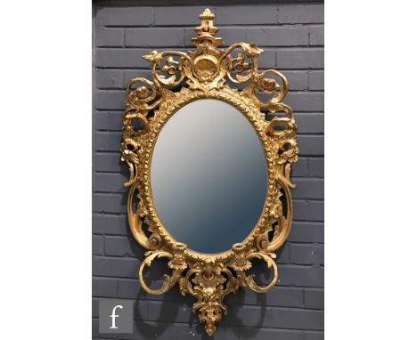 A 19th Century and later gilt framed oval girandole wall mirror, with pagoda top finial above acanthus scroll borders and con