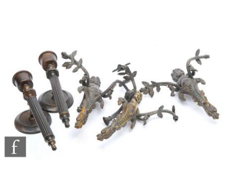 A set of three twin branch light fittings modelled as cherubs holding leafy boughs and a pair of reeded wall sconces, height 