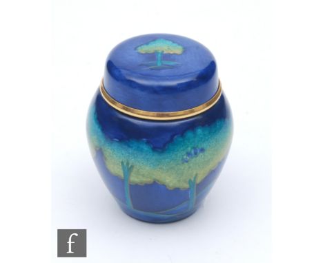A boxed Moorcroft Enamel ginger jar and cover decorated in the Moonlit Blue pattern, printed mark, height 4.8cm. 