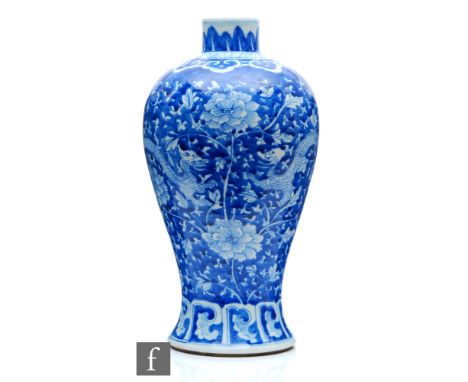 A Chinese blue and white porcelain vase, of ovoid form rising from a spreading foot, the body decorated with two dragons befo