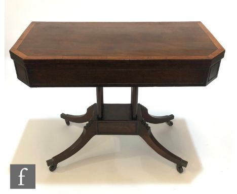 A 19th Century satinwood crossbanded mahogany tea table, the fold over canted top on four pillar supports, plinth base and sa