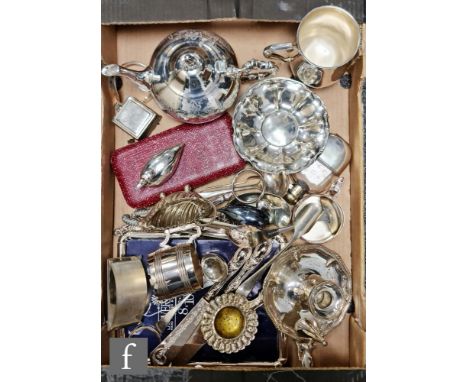 A parcel lot of assorted silver plated and white metal items to include a camber stick, photograph frame, flatware, a teapot 