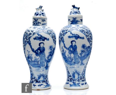 A pair of Chinese blue and white vases of baluster form, rising to a high footring and rising from a spreading circular foot,