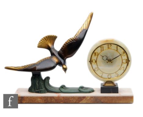 A 20th Century French Art deco mantle clock, with circular dial and Arabic numbers, decorated with a bronzed and painted styl