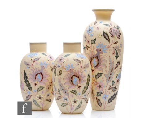 A late 19th Century French glass garniture comprising a large shouldered vase with a smaller pair of swollen ovoid examples, 