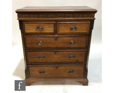 A George III oak and mahogany chequer strung and cross banded chest of two short and three long drawers, oval brass drop hand