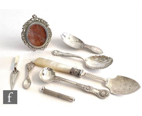 A small parcel lot of silver items to include two caddy spoons, a bookmark, a toothpick, a miniature photograph frame, spoons