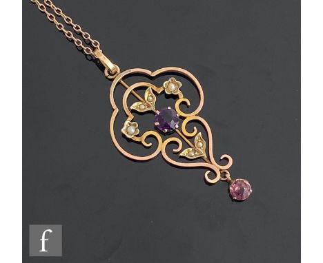 Ab early 20th Century 9ct amethyst and seed pearl set open work pendant, length 4.5cm, suspended from a 9ct trace chain, leng
