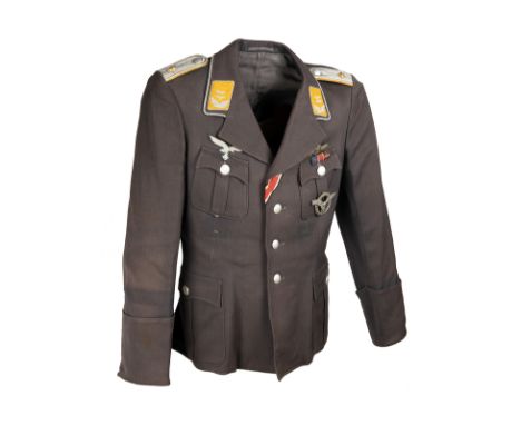 A GERMAN WORLD WAR TWO TUNIC AND PEAKED-CAP FOR AN OBERLEUTNANT IN THE LUFTWAFFE, Airforce blue with maker's label inside inn