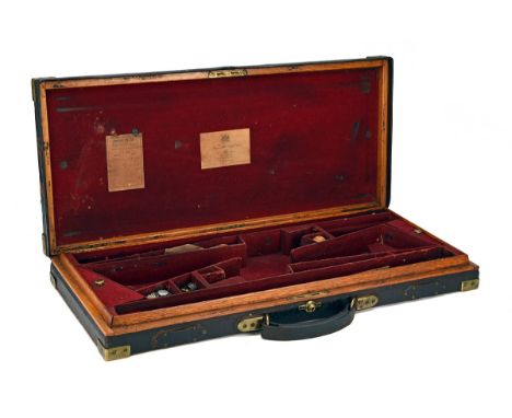 JAMES PURDEY &amp; SONS A BRASS-CORNERED OAK AND LEATHER DOUBLE GUNCASE, fitted for 28in. barrels, maroon baize-lined interio