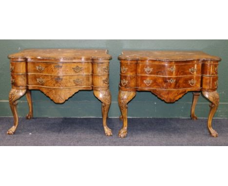 Pair of 20th century walnut lowboys, the shaped top over two bow front drawers flanked by four smaller bowed corner drawers, 