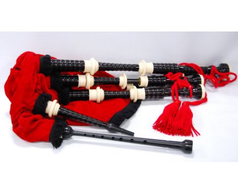 Set of bagpipes by K H Berry with red Canmore bag supplied by MacLeod Highland supplies CONDITION REPORT: K H Berry on chante