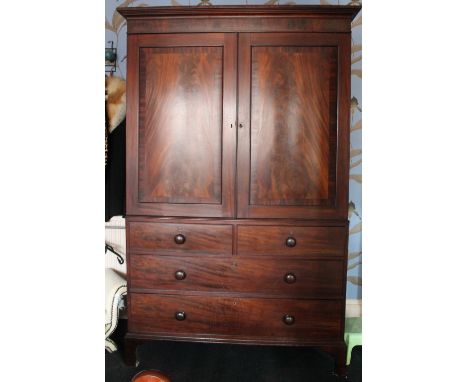 19th century mahogany linen press enclosed by pair of panel doors over two short and three long drawers CONDITION REPORT: Sli