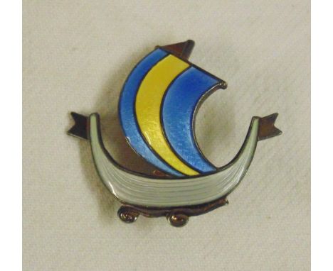 Norwegian silver and enamel brooch modelled as a Viking ship. With cream, blue and yellow enamels and stamped "Nordic Silver 