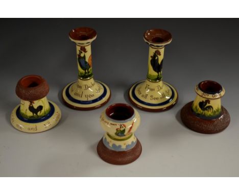 A Torquay Pottery Mottoware candlestick,  decorated with black cockerel, inscribed From Durham, Hear all, See all,  Say nothi