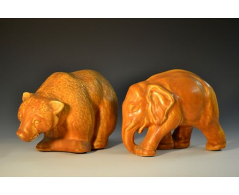 A Langley Mill Pottery model of an Elephant, striding forwards with trunk lowered, glazed throughout in mottled shades of och