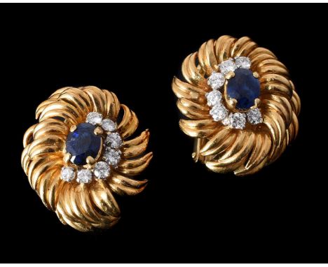 KUTCHINSKY, A PAIR OF 1960S SAPPHIRE AND DIAMOND CLUSTER EAR CLIPSthe oval cut sapphires four claw set within a crescent of b