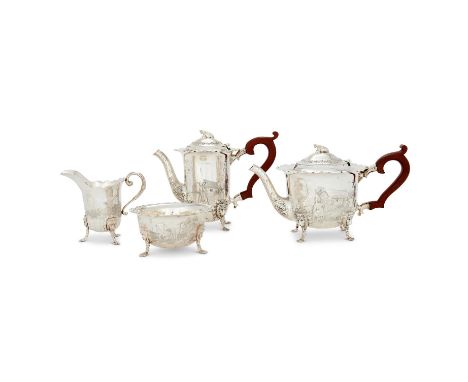 AN IRISH SILVER CIRCULAR FOUR PIECE TEA SET BY IRISH SILVER LTD. DUBLIN 1974The tea pot and hot water pot with cow finials to