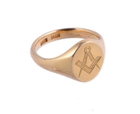A GOLD COLOURED MASONIC SIGNET RINGthe oval panel engraved with a compass and set square, the shank stamped 18ct with maker's