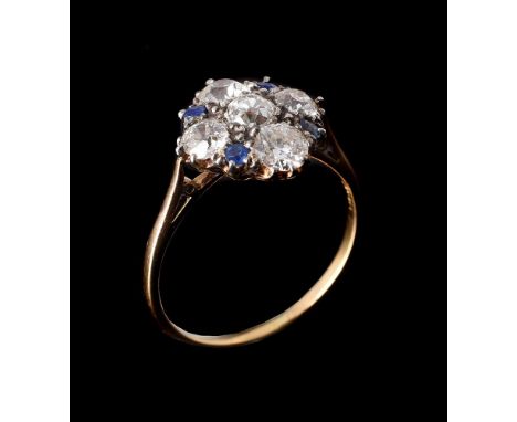 A SAPPHIRE AND DIAMOND CLUSTER RINGthe diamond quatrefoil with circular cut sapphires between, approximately 1.20 carats tota