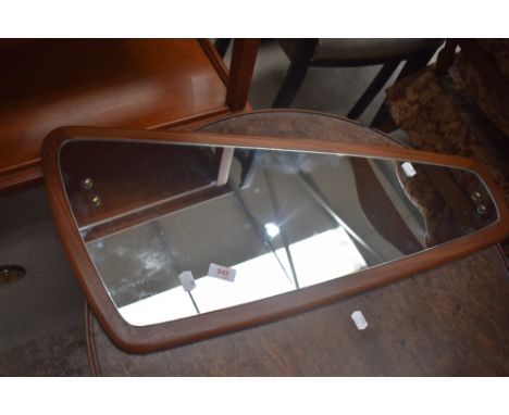 A vintage teak wall mirror, stylised shape