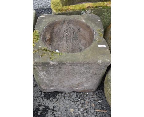 A large stone carved farm house grain mortar or planter