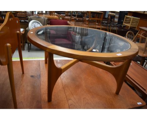 A vintage teak and glass top circular coffee table, surface scratching only