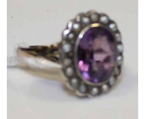 AMETHYST AND SEED PEARL CLUSTER RING
set with a central oval amethyst surrounded by seed pearls, marked 9ct & SIL for nine ca