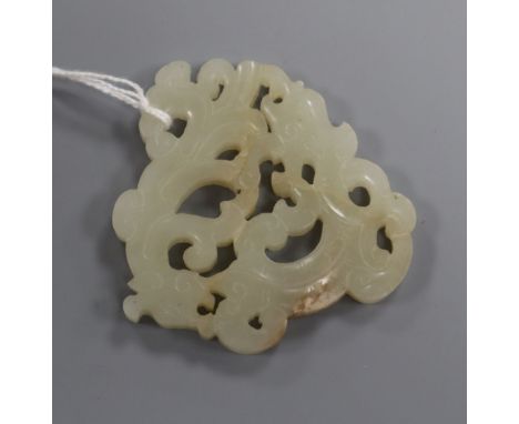 A Chinese pale celadon and russet jade 'mythical beast' plaque width 6.5cm