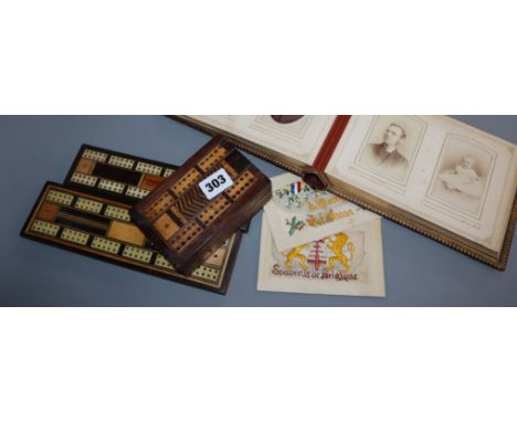 A Victorian photo album, two cribbage boards, a cribbage box and two silk cards