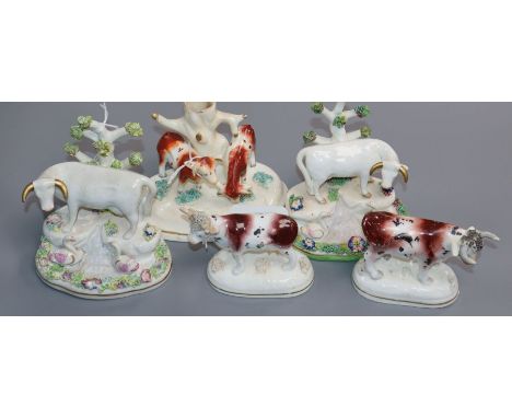 Five Staffordshire porcelain cow figures or groups, c.1830-50, including a pair by Dudson of cows with swans, a spill vase an