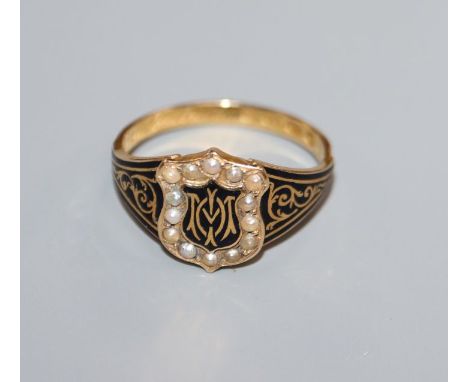 An early 19th century 18ct gold, black enamel and seed pearl set mourning ring, in memory of Mary Pemberton, size P.