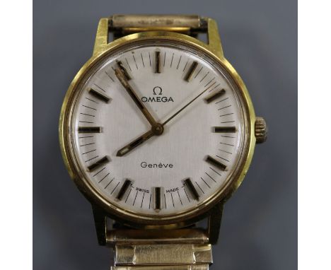 A gentleman's gold plated and steel Omega manual wind wrist watch, on associated flexible strap.