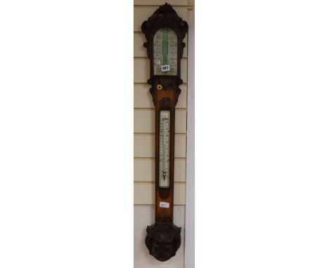 A Victorian carved oak stick barometer by G. I. Lowther, Newcastle on Tyne, in carved oak case with ivory scales and lion's h