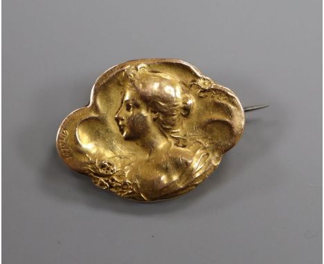 A French Art Nouveau repouse yellow metal brooch, decorated with the bust of a lady and bearing the signature 'Diolot', 30mm.