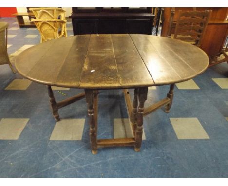 A Period Oak Drop Leaf Gate Legged Dining Table.