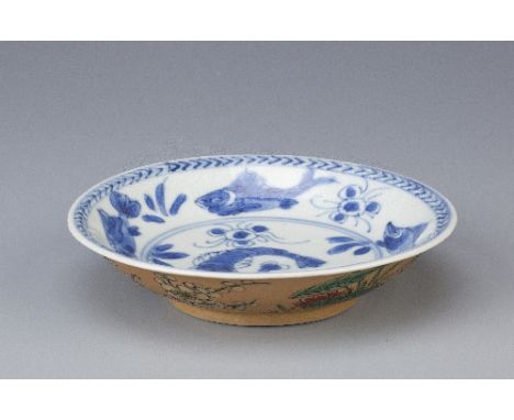 A CHINESE BLUE AND WHITE AND CAFE-AU-LAIT GROUND SAUCER KANGXI 1662-1722 Painted to the interior with fish and crustacea, a c