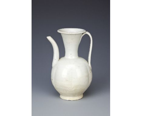A CHINESE QINGBAI EWER SONG DYNASTY The ovoid lobed body with a tall spout and a flared neck, with a paper label for the Orie