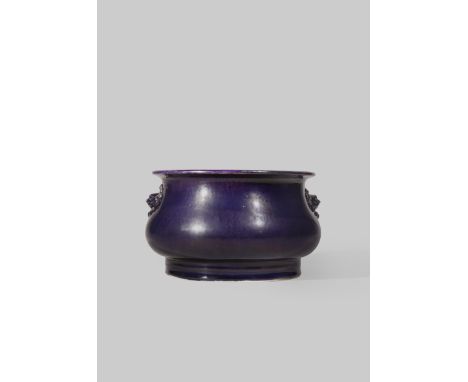A CHINESE AUBERGINE GLAZED INCENSE BURNER KANGXI 1662-1722 The bombé-shaped body with lion mask handles, raised on a straight