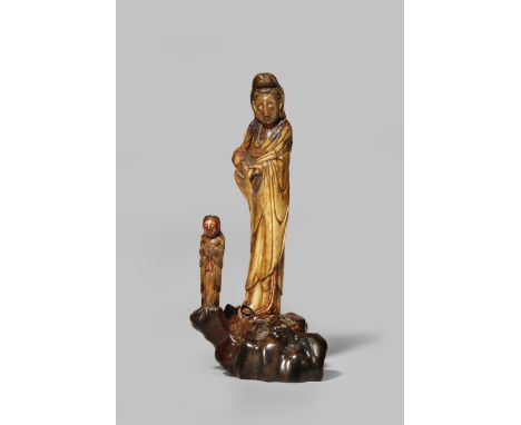 A CHINESE BONE FIGURE OF GUANYIN MING DYNASTY Standing, wearing long flowing robes, with a tall chignon covered with a veil, 