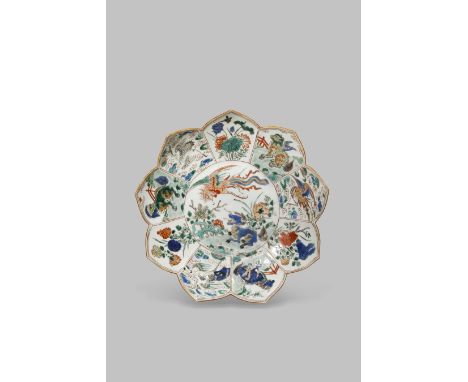 A CHINESE FAMILLE VERTE LOTUS-SHAPED DISH KANGXI 1662-1722 Painted with a phoenix in flight and a qilin amongst rockwork and 