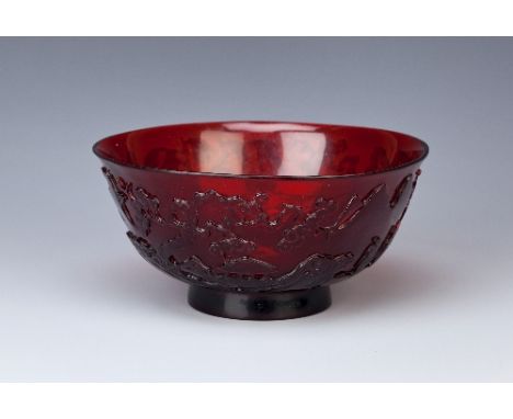 A CHINESE BEIJING RUBY-GLASS BOWL QIANLONG 1736-95 The flared body carved with four figures in a continuous landscape with pa