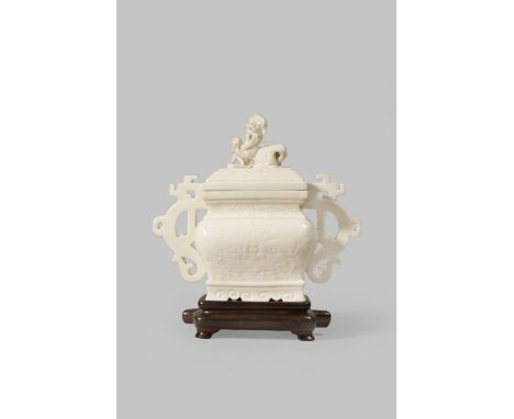 A CHINESE WHITE GLAZED ARCHAISTIC INCENSE BURNER LATE QING DYNASTY The rectangular-section body moulded with taotie masks aga