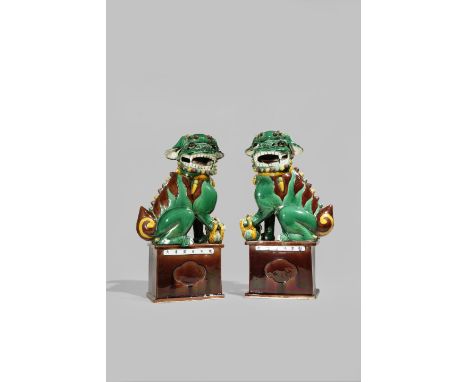 A PAIR OF CHINESE FAMILLE VERTE BUDDHIST LION DOGS 19TH CENTURY Each baring its fangs, with one paw resting on a puppy, decor
