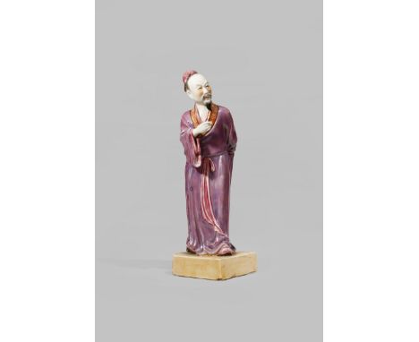 A CHINESE POLYCHROME FIGURE OF A SCHOLAR 20TH CENTURY Standing, wearing long mauve-lustre robes with iron red and gilt keyfre