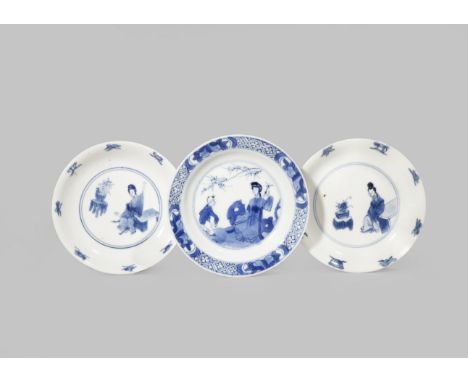 THREE SMALL CHINESE BLUE AND WHITE DISHES KANGXI 1662-1722 Comprising: a pair of saucers painted with a lady and a vase of fl