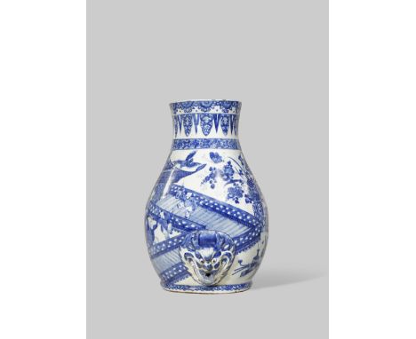 A CHINESE BLUE AND WHITE WALL CISTERN KANGXI 1662-1722 Painted with boys at play in a fenced garden, a spray of flowers in a 