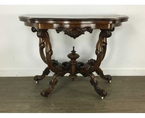 VICTORIAN FIGURED WALNUT TURNOVER TEA TABLE, of shaped outline with foliate scroll carved apron, raised on scrolled supports 